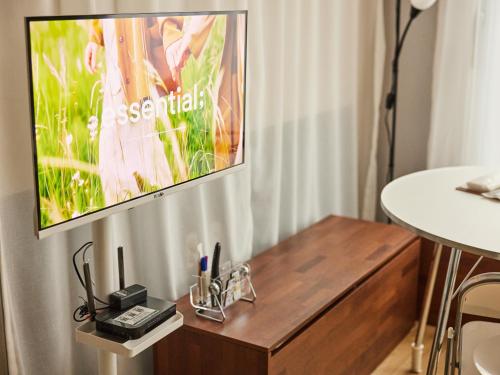 a flat screen tv hanging on a wall in a room at Stay Hankan 모던코리아라이프 in Seoul