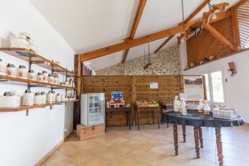 a kitchen with a table in the middle of a room at Jouandeou in Donzacq