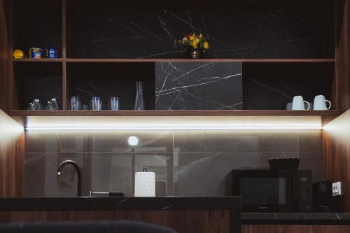 a kitchen with a counter top with a microwave at Royal Central Apartments in Zagreb
