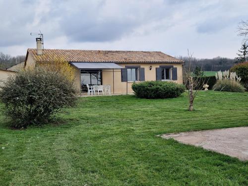 une petite maison avec une cour herbeuse devant elle dans l'établissement Chambre d'hôtes, à Saint-Martial-de-Valette