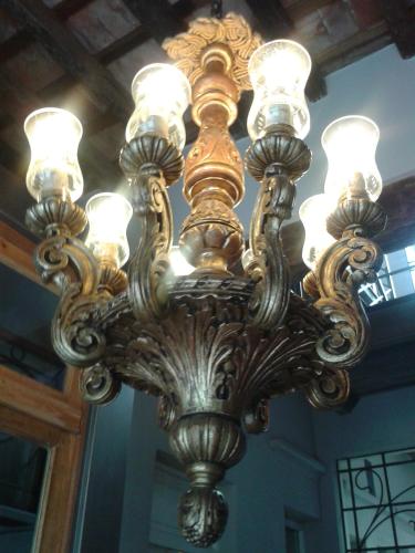 a large chandelier hanging from a ceiling at San Telmo Suites in Buenos Aires