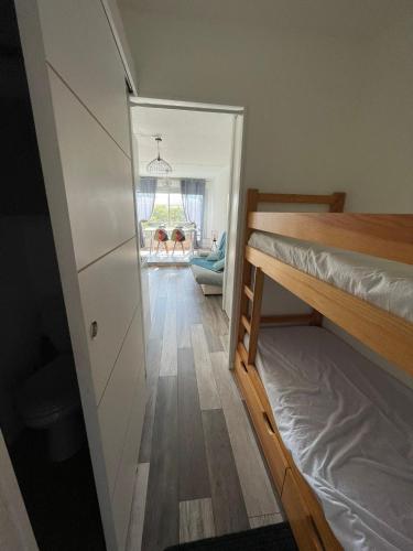Cette petite chambre dispose de lits superposés et d'un couloir. dans l'établissement Joli studio cabine centre port la baleine rose, au Cap d'Agde