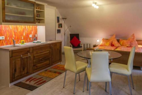 a kitchen with a table and chairs and a bed at Wohnung In Niedergurig Mit Grill, Sauna Und Garten in Malschwitz