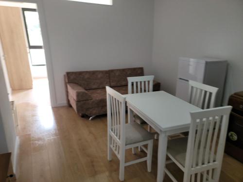 a living room with a table and chairs and a couch at Tedi's Nest in Vlorë