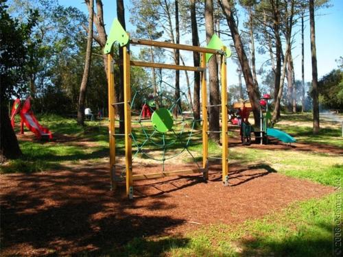 a park with a playground with a swing at Residencial Boavistense by Umbral in Odemira