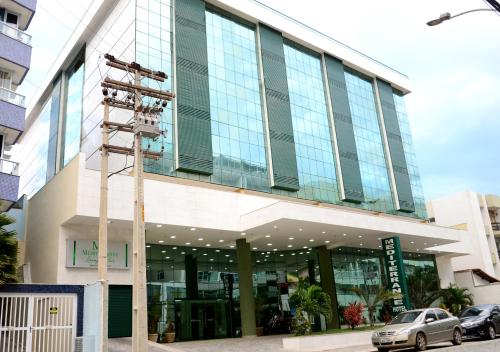a large building with a lot of windows at Mediterrane Hotel by Castelo Itaipava in Arraial do Cabo