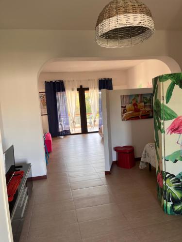 a living room with a hallway with a tile floor at La casina di Shabbi in Vulcano