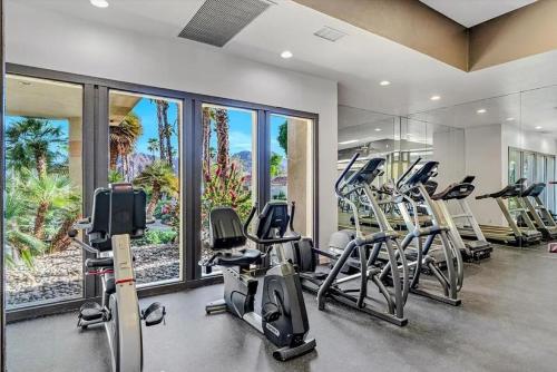 a gym with several treadmills and elliptical machines at Desert Breezes Resort in Palm Desert