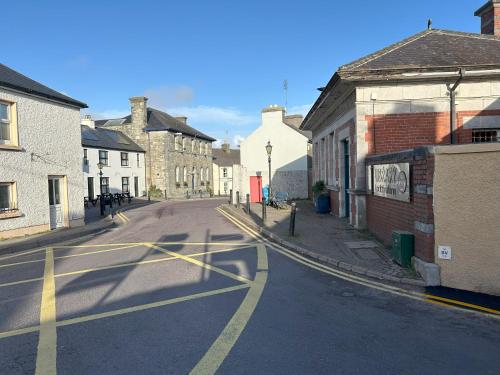 an empty street in a town with buildings at Number 7 Bank House in Schull