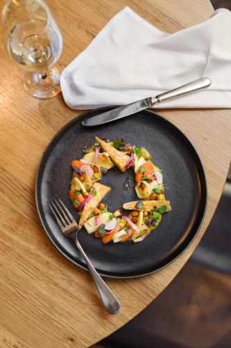 a plate of food with a salad on a table at B2 Hotel Zürich in Zürich