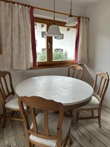 a table and chairs in a room with a window at Haus Berger in Bayrischzell