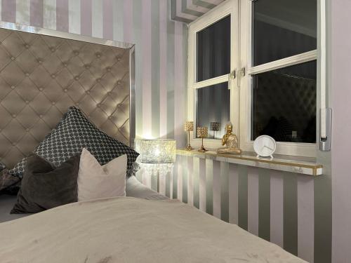 a bedroom with a large bed and a window at Classico Uno in Meckenbeuren