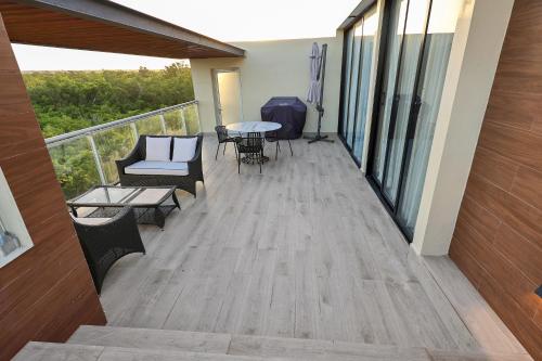 a balcony with furniture and a table and chairs at 404 y 504 Luxurious PH with Jacuzzi near the Beach in La Laguna