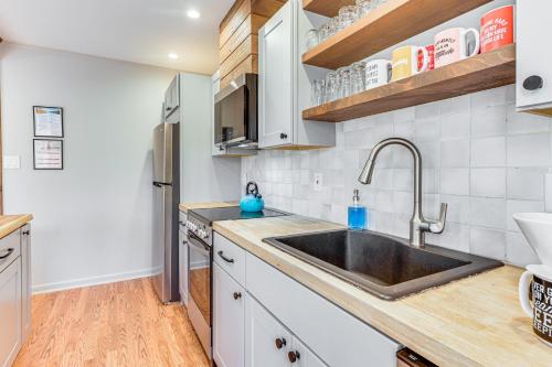 a kitchen with a sink and a refrigerator at Fireside Lodge A-Frame in Bryce Resort with Decks in Basye