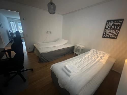 a room with two beds and a desk and a chair at Amerikavägen 9 in Skellefteå