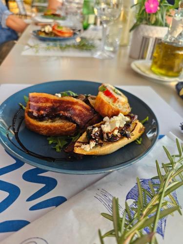 a blue plate of food on a table at Boutique Resort OSMA - Adults Only in Malinska