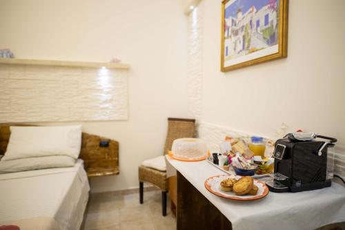a room with a table with a plate of food on it at B&B Pilella in Alliste