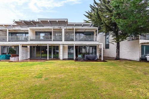a large house with a yard in front of it at Villa Oasis in Troia
