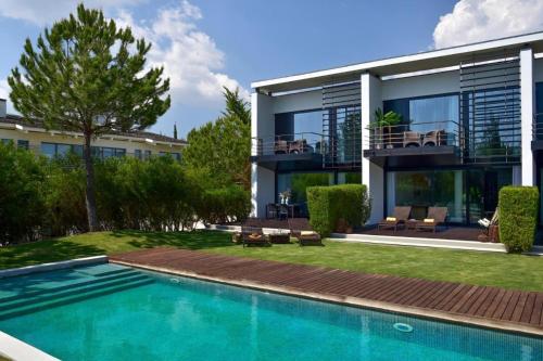 a house with a swimming pool in front of it at Villa Oasis in Troia