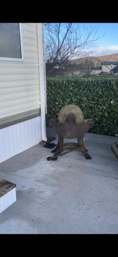 a wheelbarrow sitting outside of a house at 1 Gullion Lodge Newry in Newry