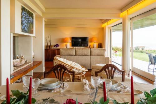 a living room with a table and a couch at The Princess Ring View in Vila Franca do Campo