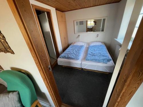 a small room with two beds and a mirror at Marskferie Tønder in Tønder