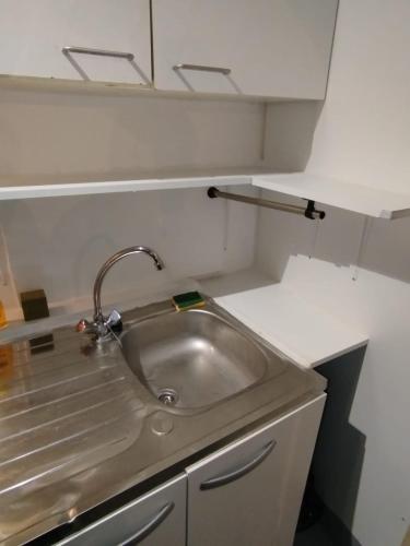 a kitchen with a sink in a small room at Centre ville Bagnols sur Cèze in Bagnols-sur-Cèze