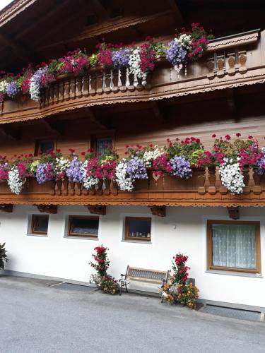 a building with flower boxes on the side of it at Haus Binder in Ried im Zillertal