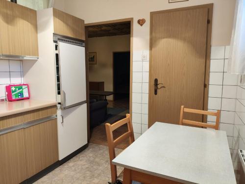 a kitchen and dining room with a table and a door at Traun Apartment in Linz