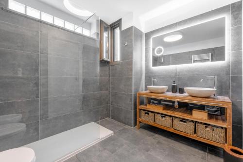 a bathroom with two sinks and a mirror at Milano-Rho Fiera Exclusive stay private parking in Rho