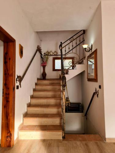 a staircase in a house with wooden floors at Hidden Gem Villa in Guri i Zi