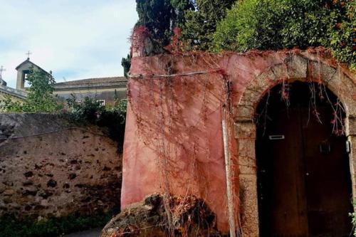 a red brick wall with a door in it at La Siciliana in Acireale