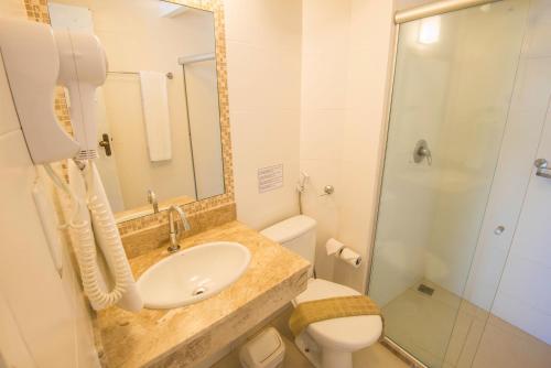 a bathroom with a sink and a toilet and a shower at Pousada Ilha da Saudade in Morro de São Paulo
