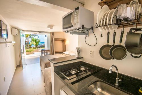 a kitchen with a sink and a counter top at Pousada Ilha da Saudade in Morro de São Paulo