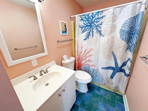 a bathroom with a sink and a shower curtain at D109A- Moby Duck in Sanderling