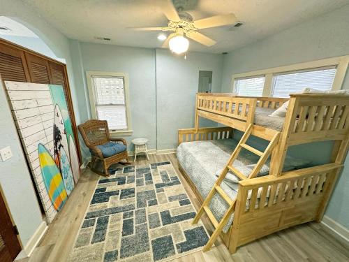 a bedroom with two bunk beds and a ceiling fan at D109A- Moby Duck in Sanderling