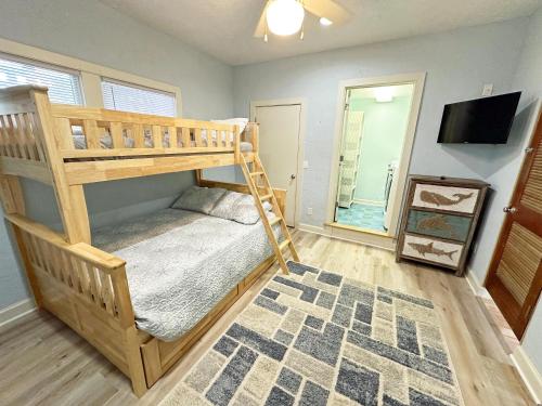 a bedroom with a bunk bed and a mirror at D109A- Moby Duck in Sanderling