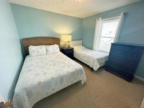a bedroom with two beds and a window at KD1401D- Kiki's Haven in Kill Devil Hills