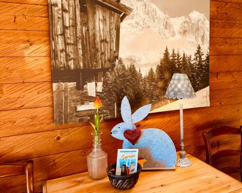 a wooden table with a heart shaped figurine on it at TONIS cozy Guesthouse by Alpin Charme Apartments in Reith bei Kitzbühel