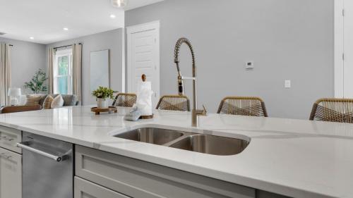 a kitchen with a sink and a counter top at Queen Palm in Inlet Beach
