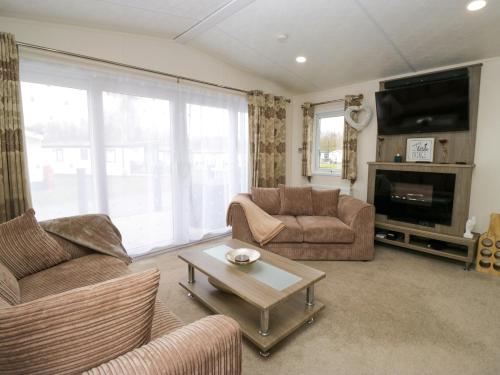 a living room with two couches and a coffee table at 3 Yealands in Carnforth