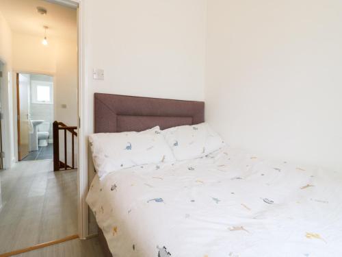 a bedroom with a bed with white sheets and pillows at Ninety Eight in Southend-on-Sea