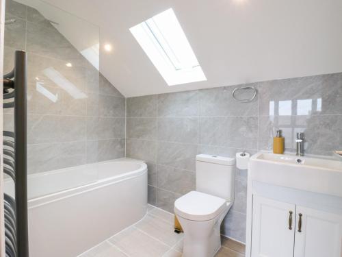 a bathroom with a white toilet and a sink at Ninety Eight in Southend-on-Sea