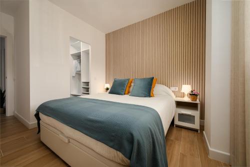a bedroom with a bed with blue and orange pillows at Sunset Vibes Mijas in La Cala de Mijas
