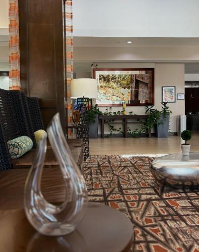 a lobby with a glass chair and a living room at Kozy Hotel Houston North in Westfield