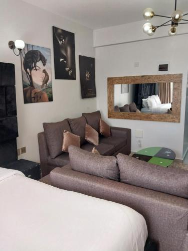 a living room with a couch and a mirror at Hellen's Condo in Nairobi