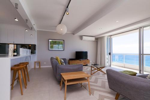 a living room with a couch and chairs and a table at Points North Apartments in Gold Coast