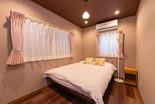 a bedroom with a bed in a room with a window at Y's INN Tsutusji 014T in Tokyo