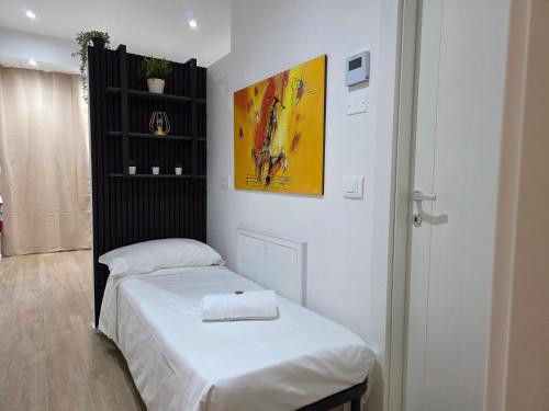 a bedroom with two beds and a painting on the wall at La Ca' Gobetti Affittaly Apartments in Bologna