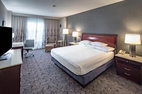 a hotel room with a bed and a television at DoubleTree by Hilton Modesto in Modesto